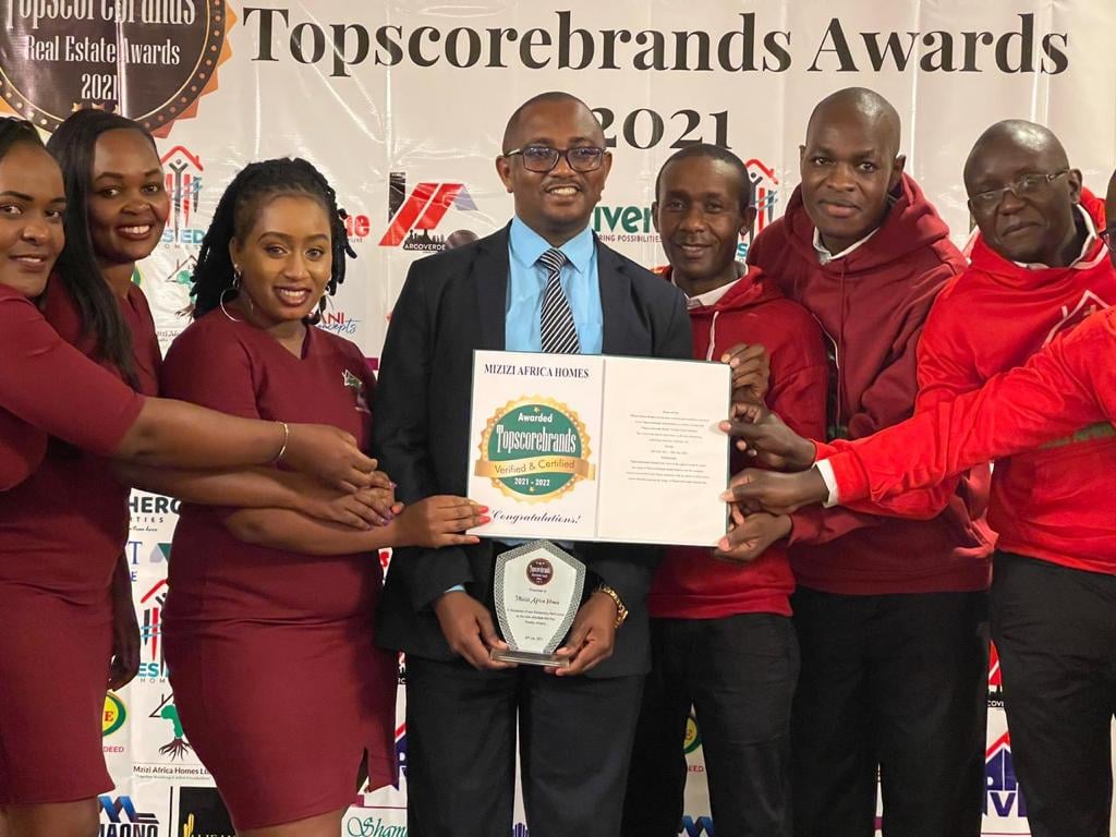 Mizizi Africa Homes CEO George Mburu(In the Middle) and Marketing Team holding the award